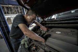 Man working on car engine