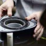 A close up shows a person handling a rotor.