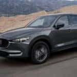 A grey 2022 Mazda CX-5 is shown from the front at an angle after leaving a Lake Murray Mazda dealer.