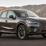 A dark grey 2019 Mazda CX-5 is shown parked on pavement.