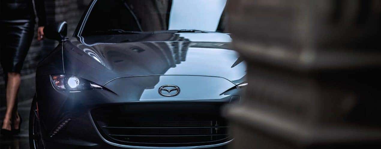 A close up shows the front of a dark grey 2023 Mazda MX-5 Miata RF.