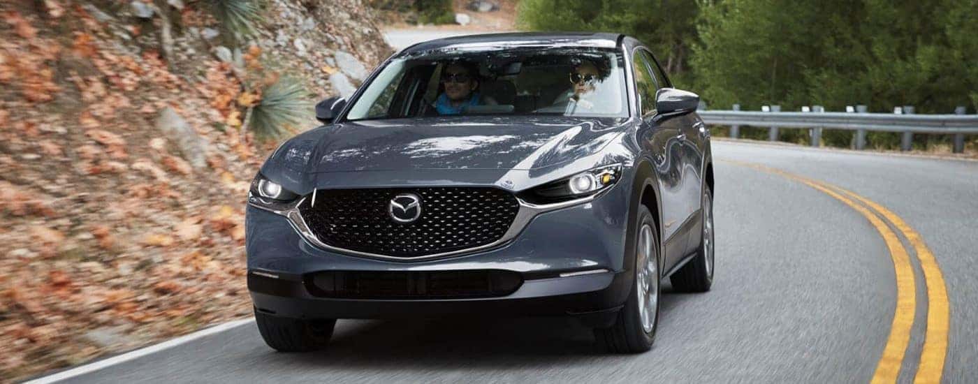 A grey 2021 Mazda CX-30 is shown rounding a corner.
