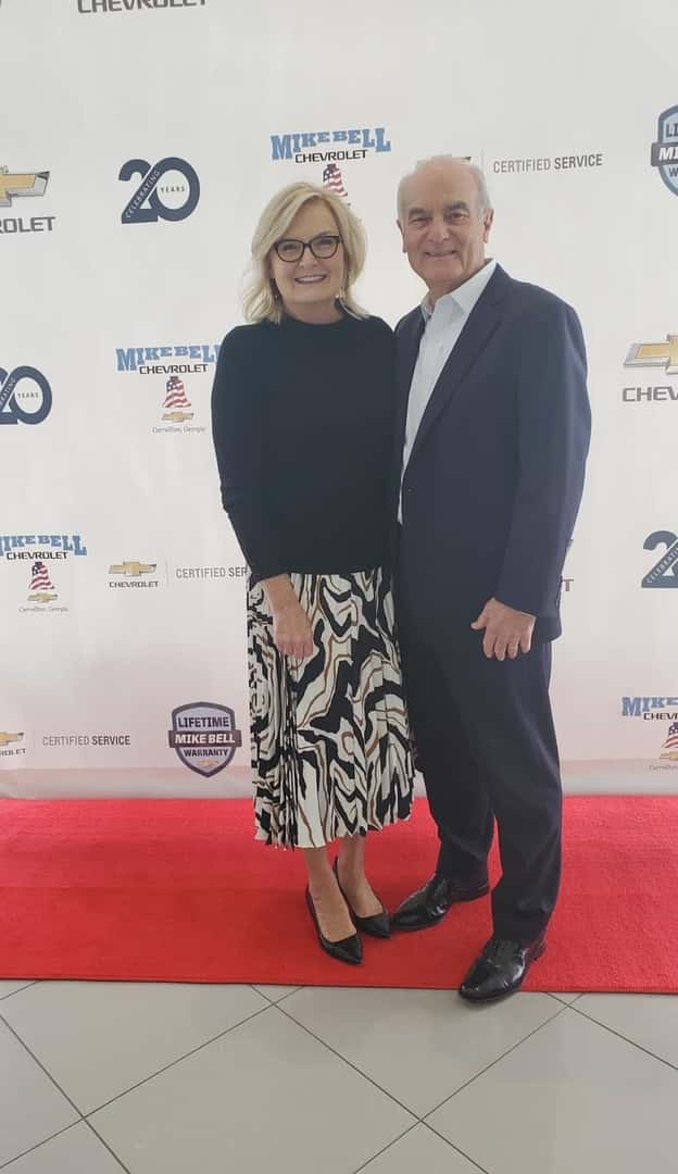 standing on red carpet