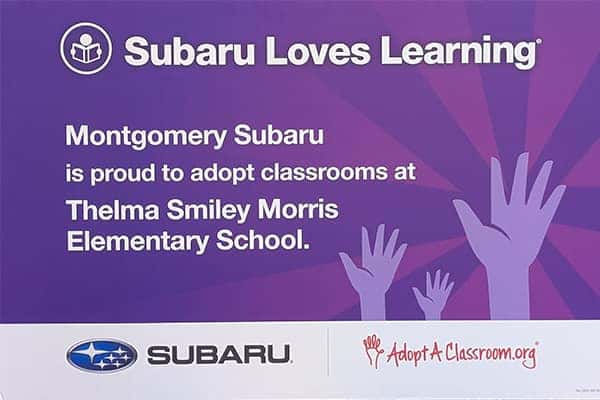Classroom of teachers holding Subaru Loves Learning donations