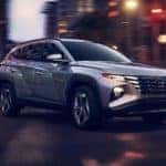 The all-new 2022 Hyundai Tucson making a turn in a city.