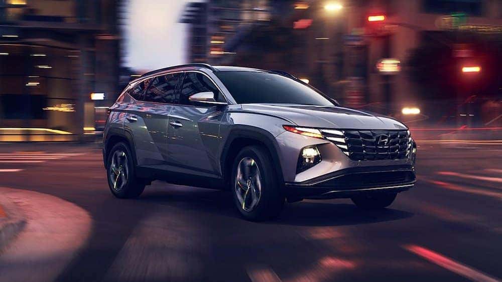 The all-new 2022 Hyundai Tucson making a turn in a city.