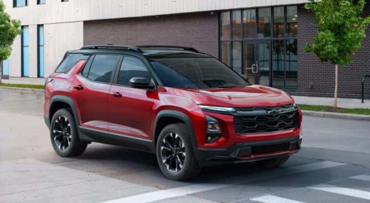 A red 2025 Chevy Equinox RS is shown at an intersection.