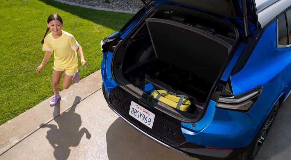 The rear cargo area is shown in a blue 2025 Chevy Equinox EV.