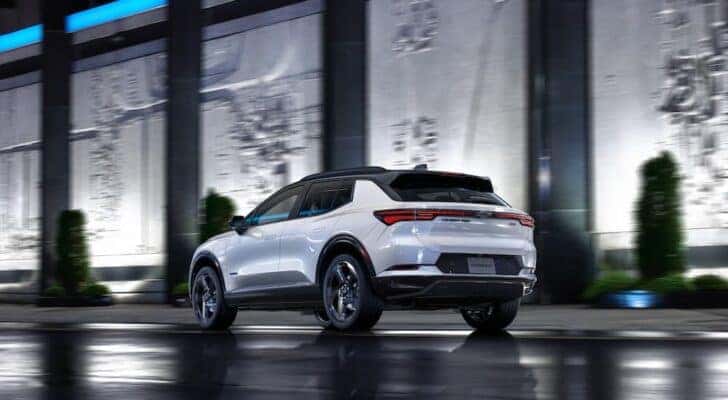 A white 2025 Chevy Equinox EV is shown from the rear at an angle.