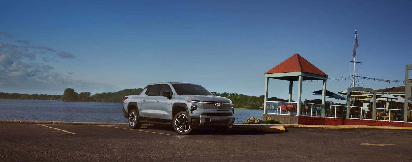 A blue 2025 Chevy Silverado EV is shown from the front at an angle.