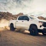A white 2024 Chevy Silverado for sale from the side.