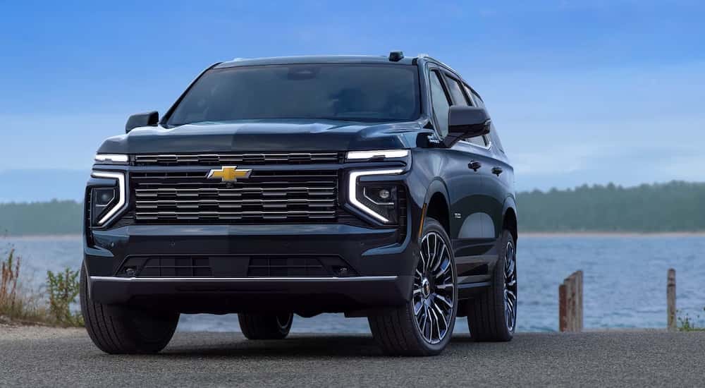 A black 2025 Chevy Tahoe for sale parked near a lake.