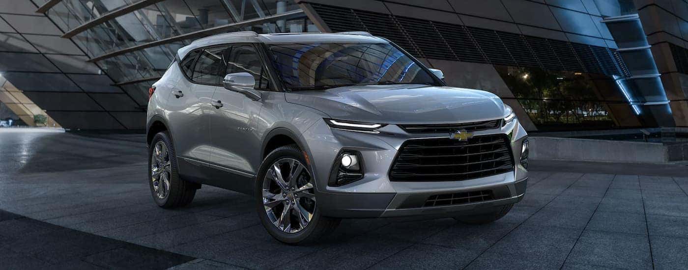 A silver 2022 Chevy Blazer for sale parked outside a building.