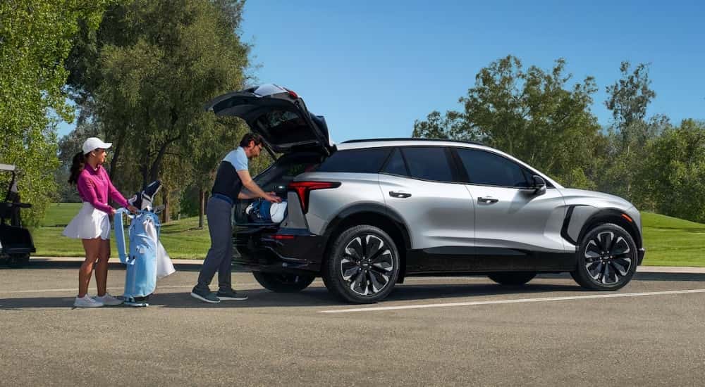 A silver 2025 Chevy Blazer EV is at a golf course.