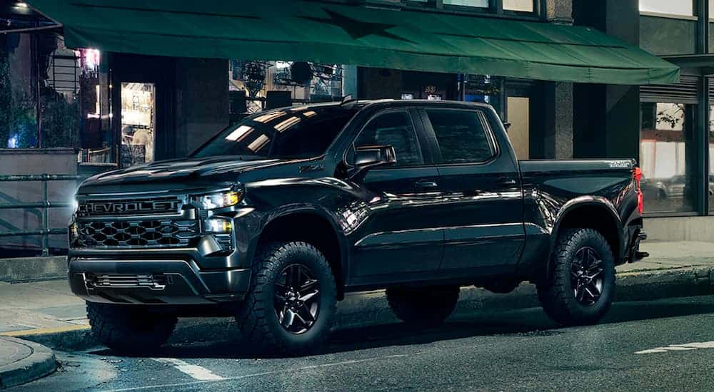 A black 2025 Chevy Silverado 1500 on a street.