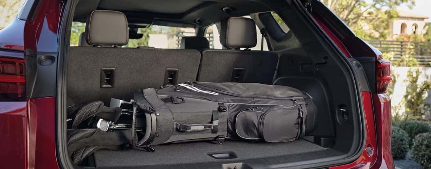 Golf clubs in the rear cargo area in a red 2025 Chevy Blazer for sale near Cornelius.