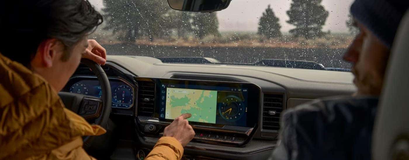 A person using the infotainment screen in a 2025 Chevy Silverado 1500 for sale near Mooresville.