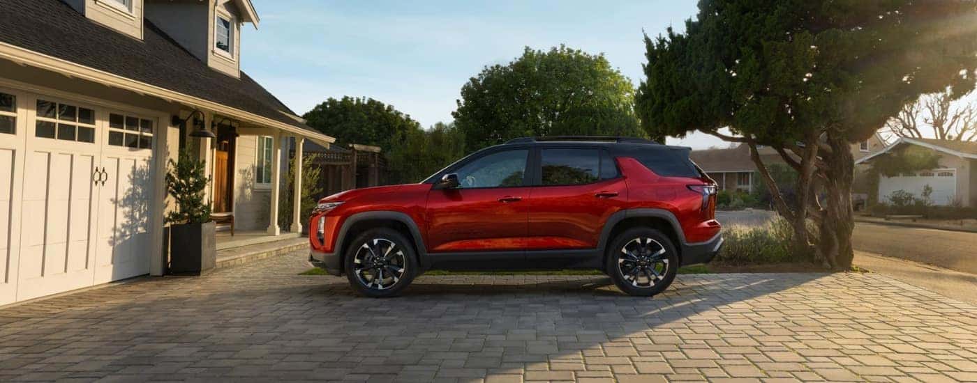 A red 2025 Chevy Equinox RS parked on a driveway.