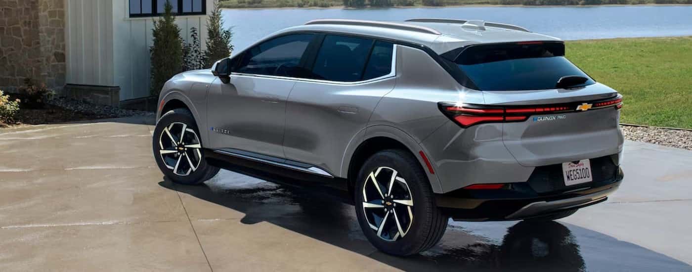 A silver 2024 Chevy Equinox EV parked on a driveway.