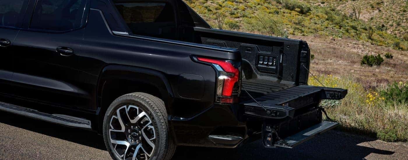 A black 2025 Chevy Silverado EV from the side.