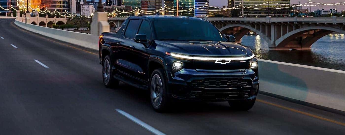 A black 2025 Chevy Silverado EV for sale near me from the front at an angle.