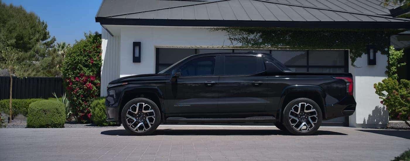 A black 2025 Chevy Silverado EV from the side.