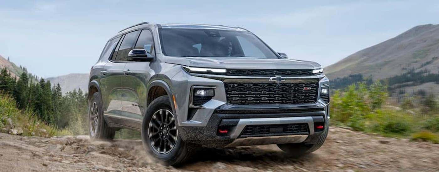 A silver 2025 Chevy Traverse driving off-road