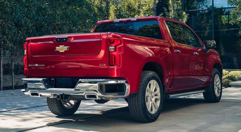 A red 2025 Chevy Silverado 1500 LTZ parked in a driveway