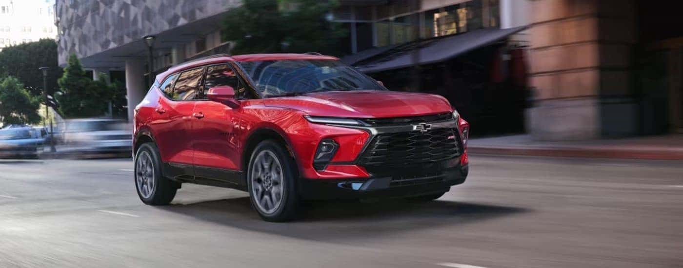 A red 2023 Chevy Blazer RS driving down a street