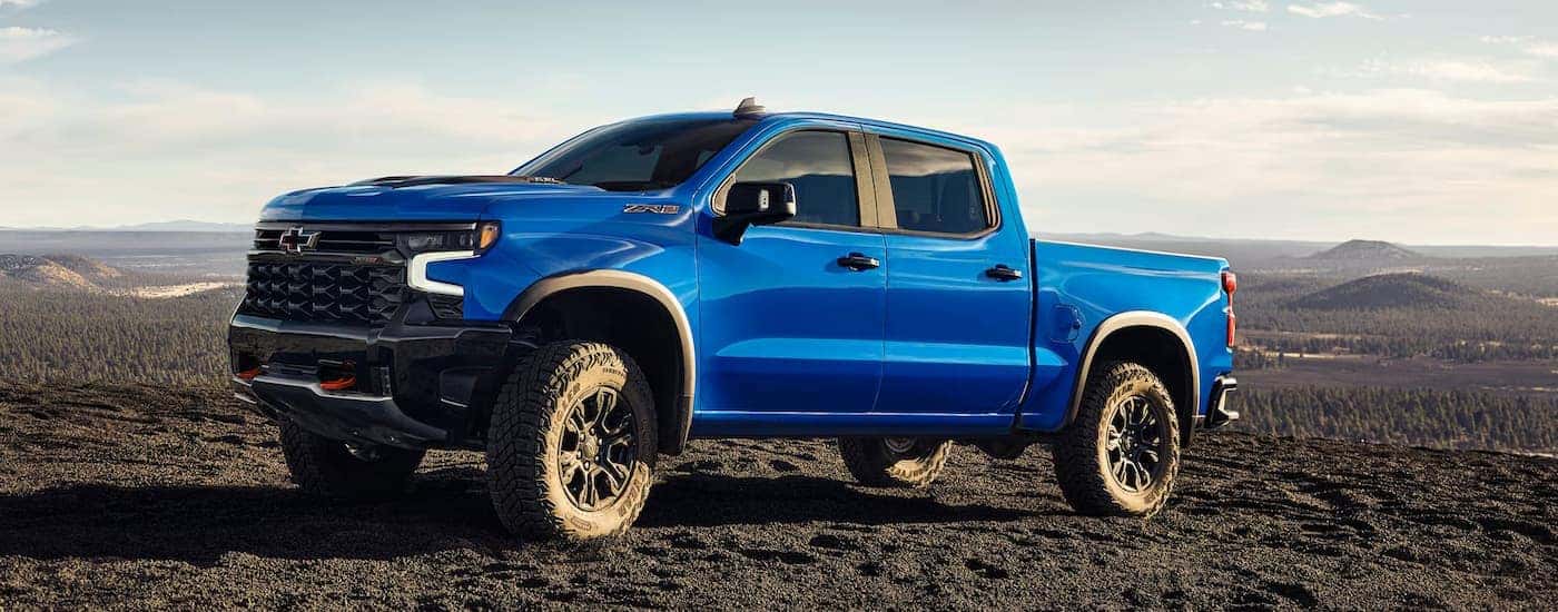 A blue 2025 Chevy Silverado 1500 parked off-road for sale near Kannapolis