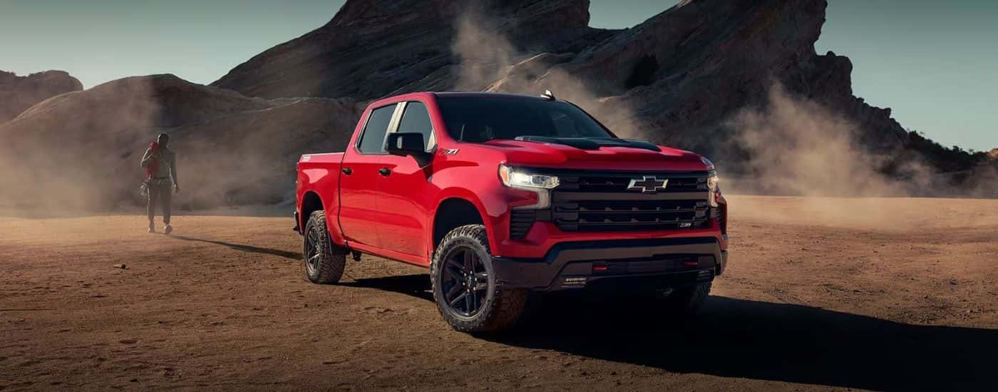 A red 2023 Chevy Silverado parked off-road for sale near Cherryville