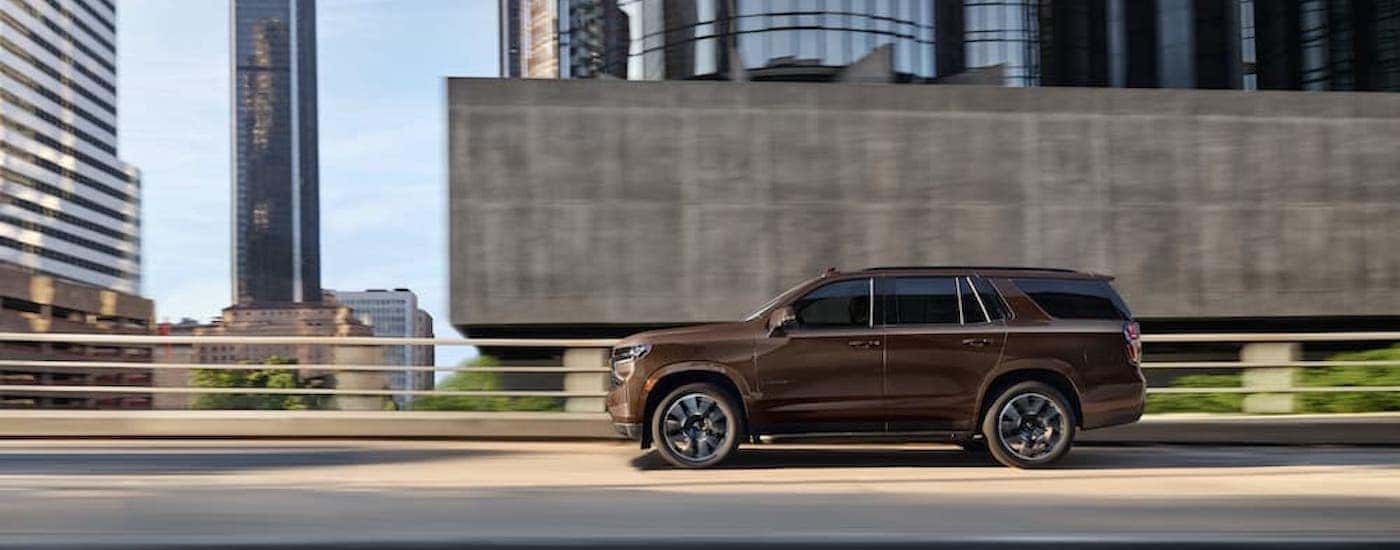 A brown 2022 Chevy Tahoe from the side.