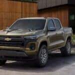 A green 2025 Chevy Colorado Z71 for sale parked near a house.