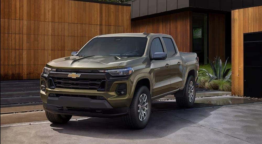 A green 2025 Chevy Colorado Z71 for sale parked near a house.
