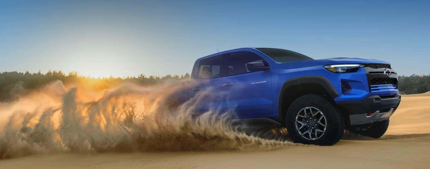 A blue 2026 Chevy Colorado off-roading for sale near Mooresville
