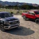 One Blue Ram Truck and One Red Ram Truck on Dusty Road