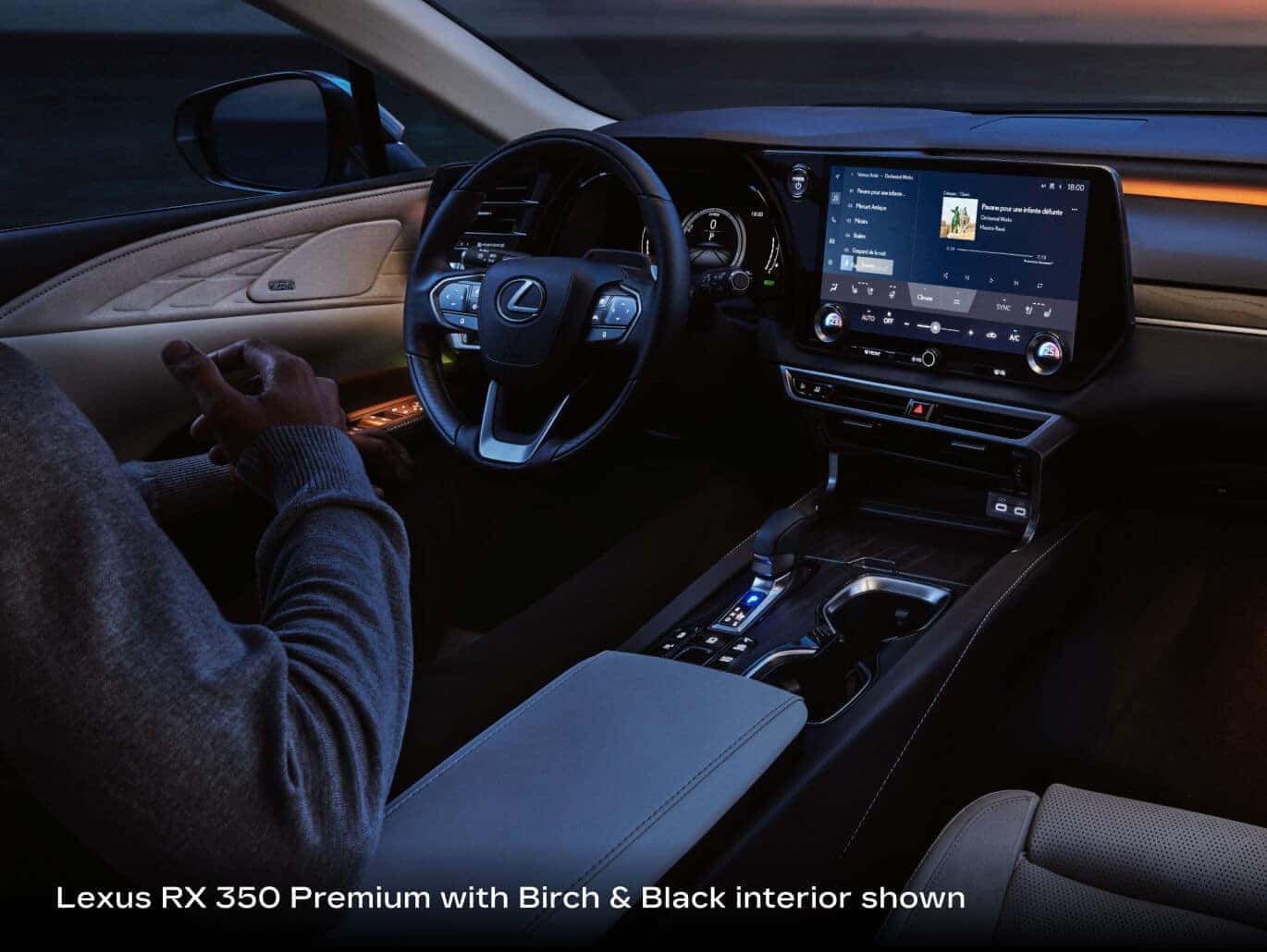2026 Lexus RX 350 Premium with Birch & Black interior, front cabin view showing driver, steering wheel, touchscreen and console.