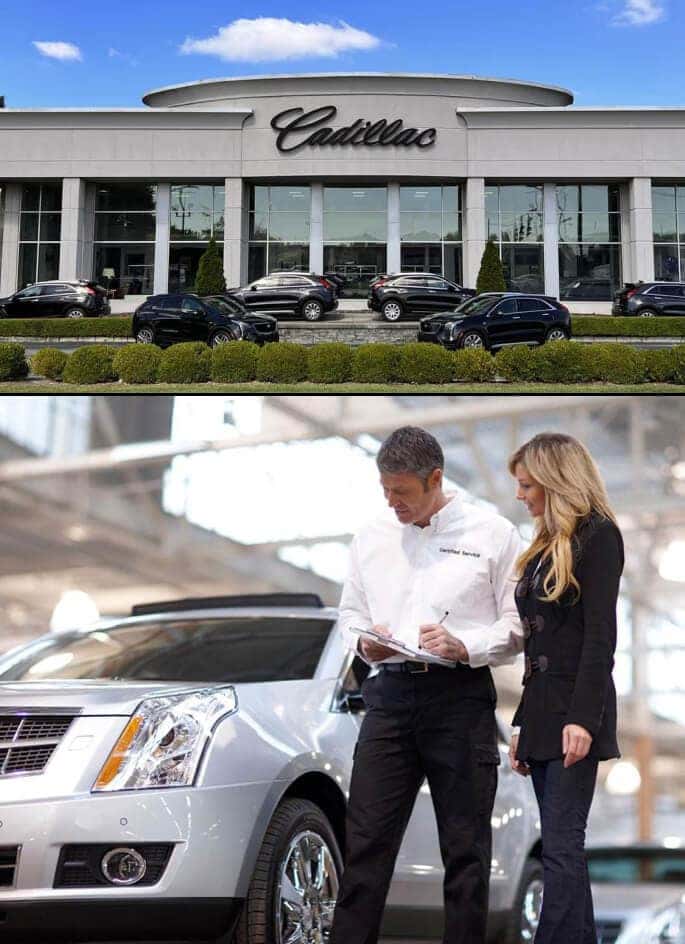 Exterior street view of Quantrell Cadillac facade. A service technician inside a dealership walks a customer around a pre-owned Cadillac vehicle.