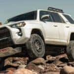 White 2019 Toyota 4Runner offroading over rocks