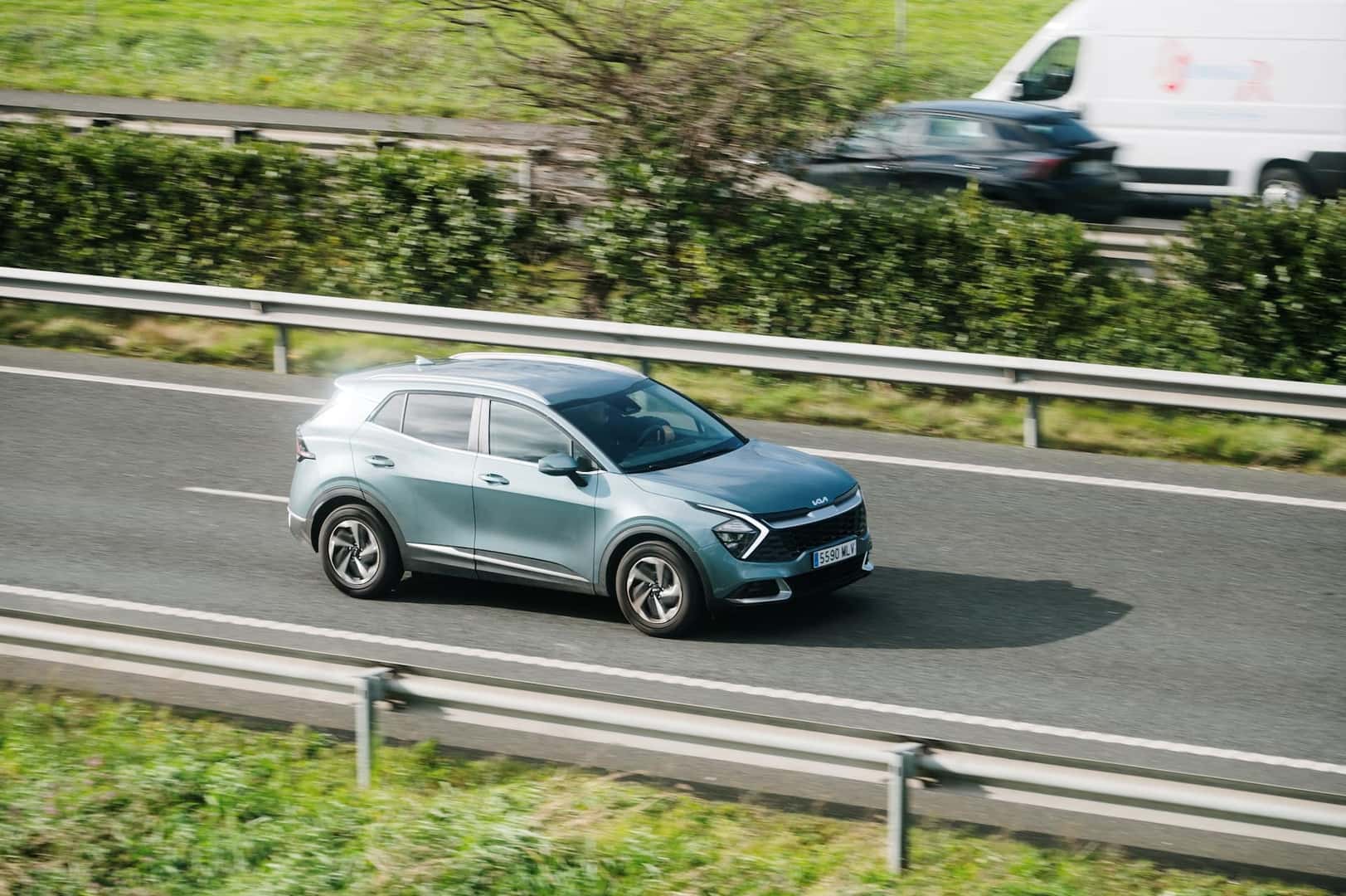 A Kia Sportage in motion on a highway