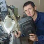 Man working with a welder at Sunroad Collision Center