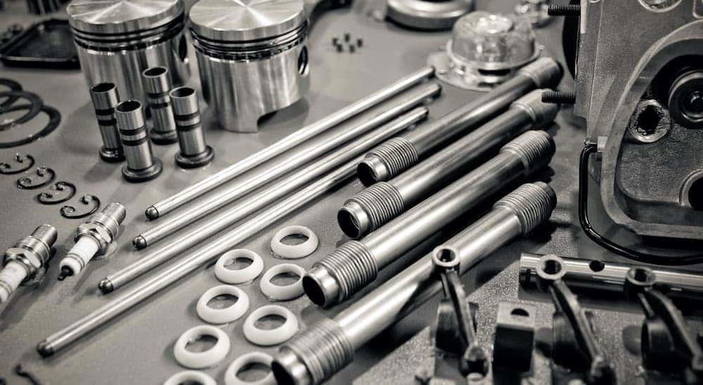 A close up shows an assortment of car parts.