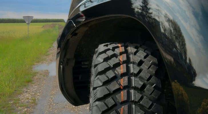 A close up shows the tread on a truck tire.