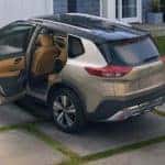 A gold 2021 Nissan Rough is shown parked in a driveway after leaving a Nissan Rogue dealership.
