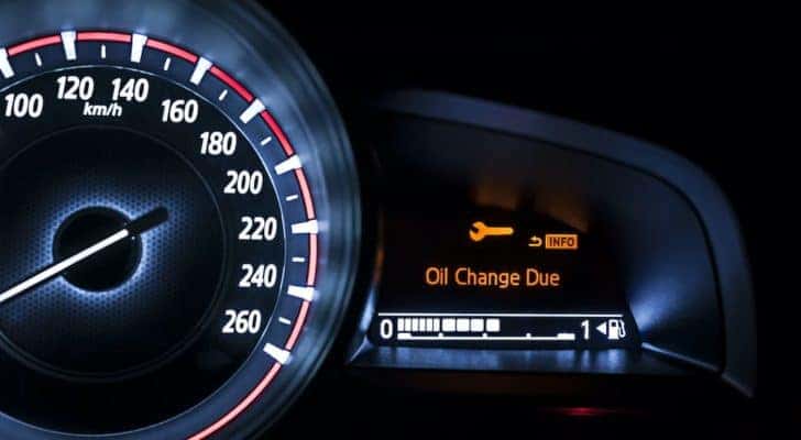The dashboard shows the oil light illuminated.