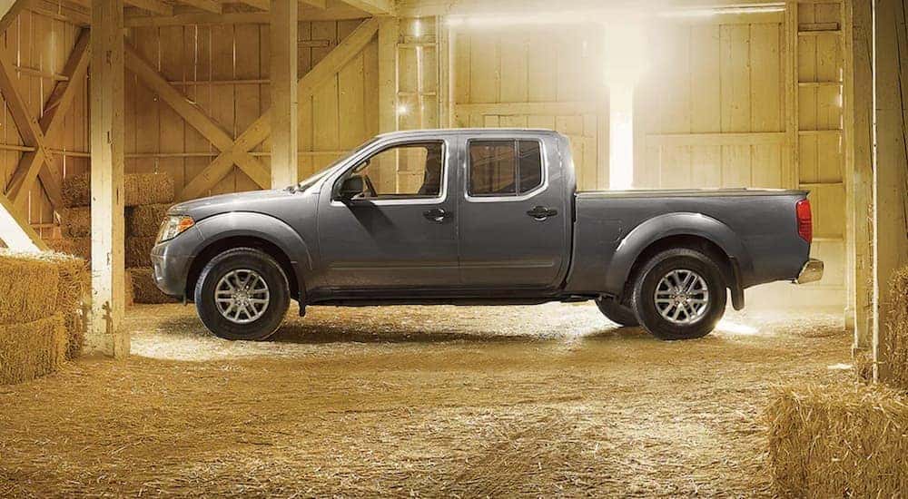 A grey 2021 Nissan Frontier is shown in a barn after leaving a used Nissan truck dealer.