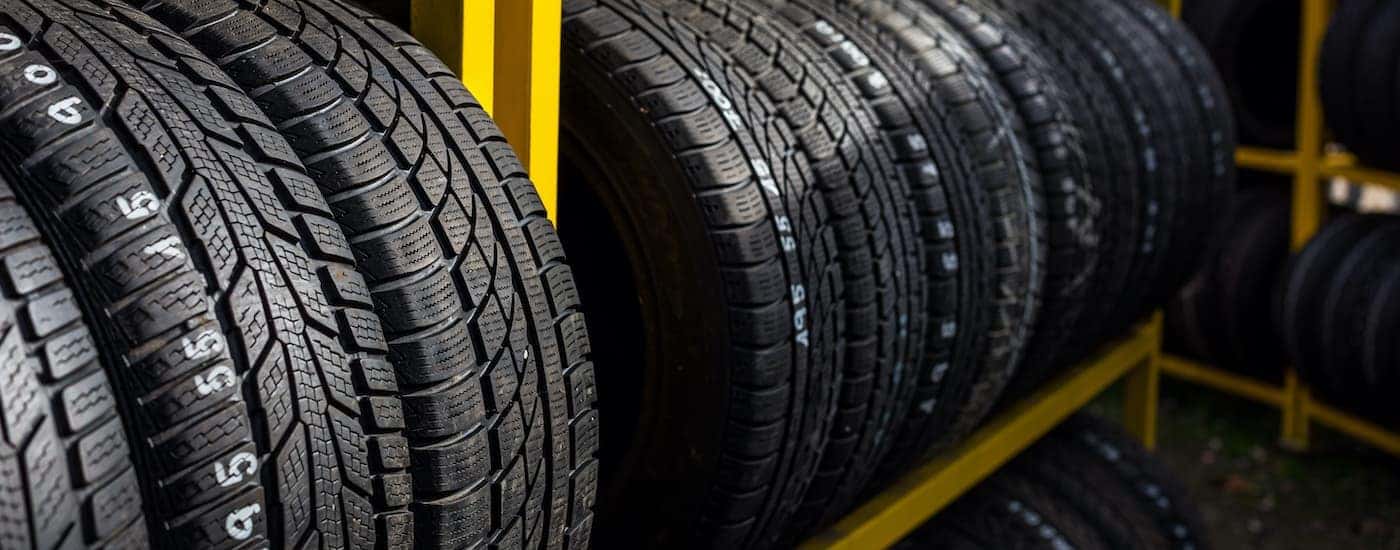 A yellow tire rack is shown full of affordable tires near you.