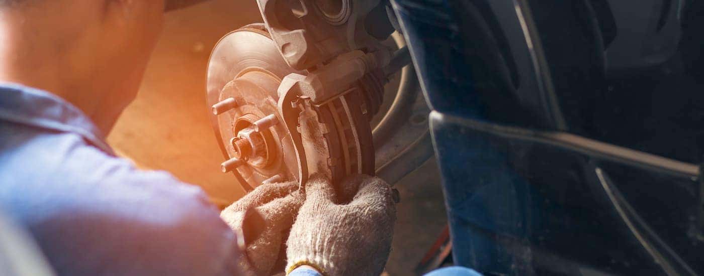 A mechanic is shown working on a rotor replacement.