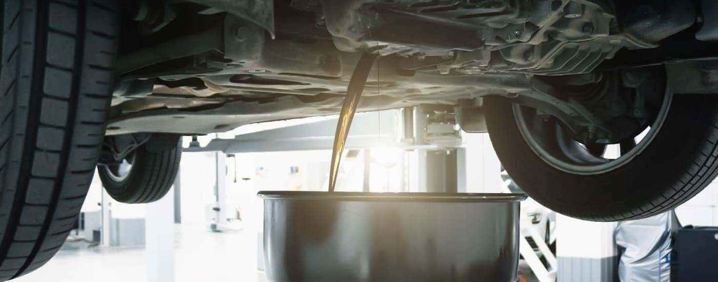 Oil is shown being drained during an oil change.