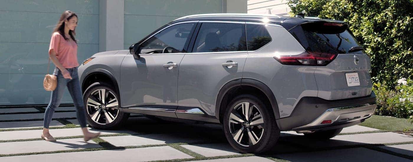 A grey 2022 Nissan Rogue is shown in a driveway.